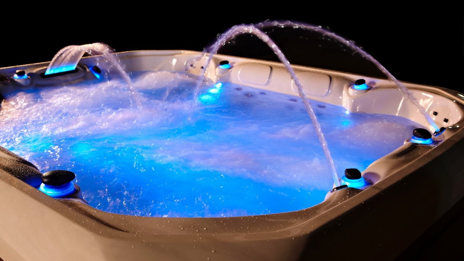 Blue-lit water detail in the hot pool at dusk