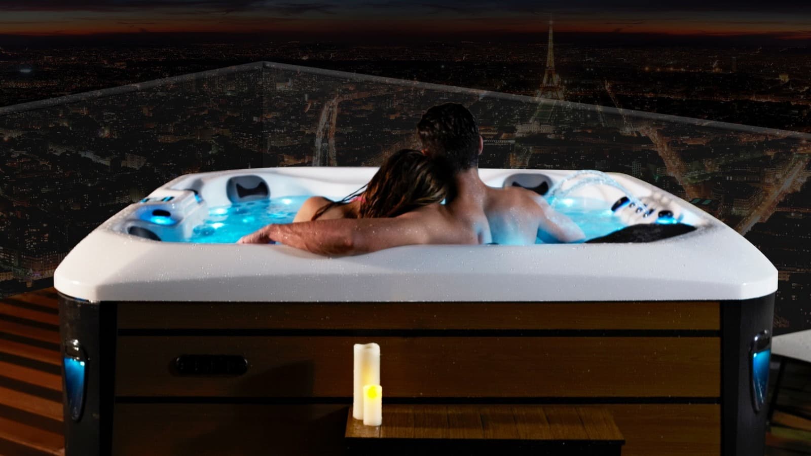 A couple relaxing in the outdoor hot pool overlooking the lake